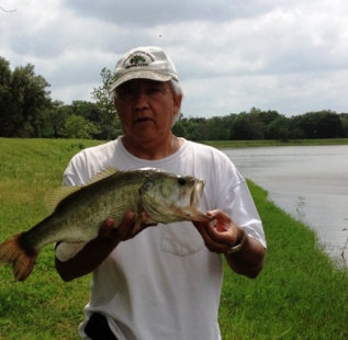 Tony Oviedo holds a 22 inch bass at Damon Live Oak Fish Farms.